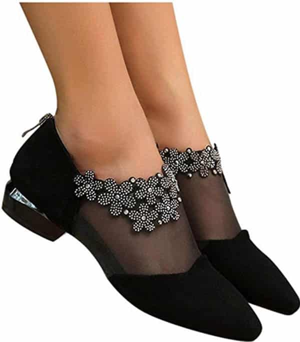 Black shoes with sheer panels and flower embellishments.