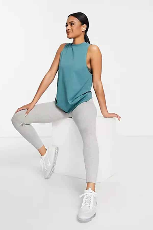 9 best online stores to buy affordable workout clothes for women 3 Model wearing workout tank top and pants from ASOS.
