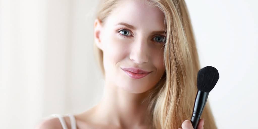 Woman holding makeup brush