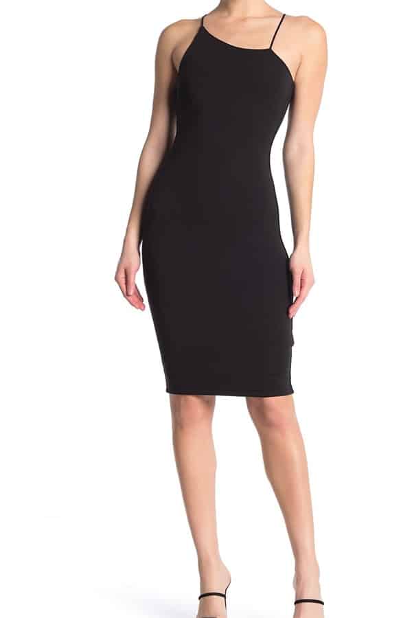 Woman wearing black asymmetric bodycon dress 