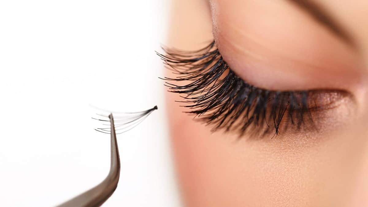 Woman applying fake eyelashes