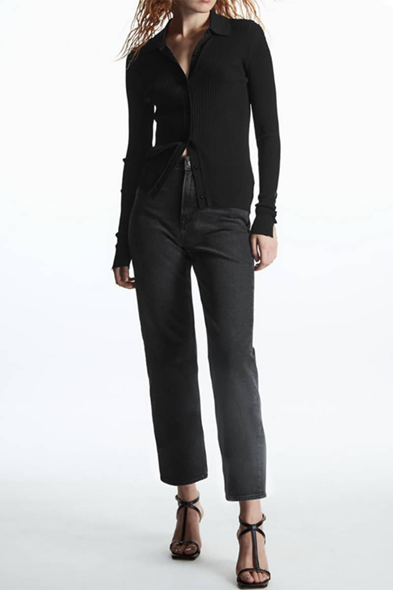 Model wears all-black outfit from COS, a popular midrange fashion store.