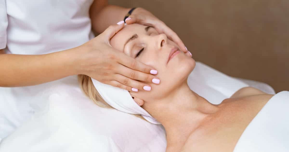 Woman gets facial massage.