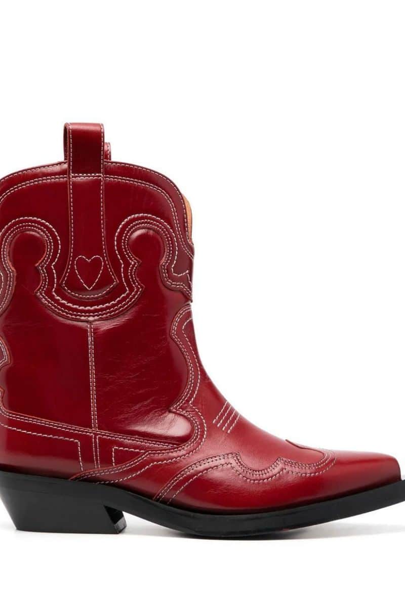 Red Ganni cowboy boot discounted in Farfetch sale.
