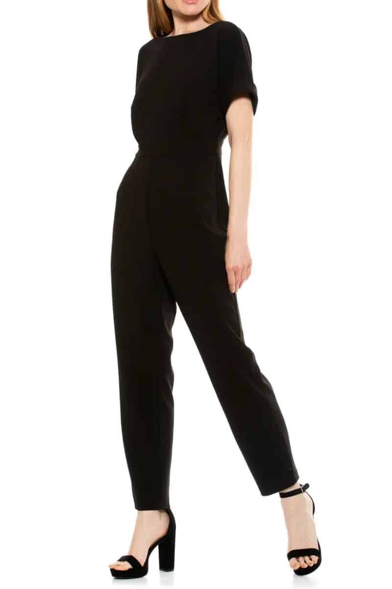 Black jumpsuit showing one fashion rule of wearing jumpsuits after 50, to choose styles that emphasize the waist.