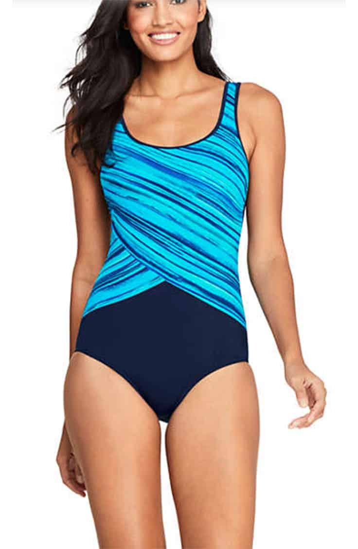 Tall woman wearing one-piece swimsuit with patterned top