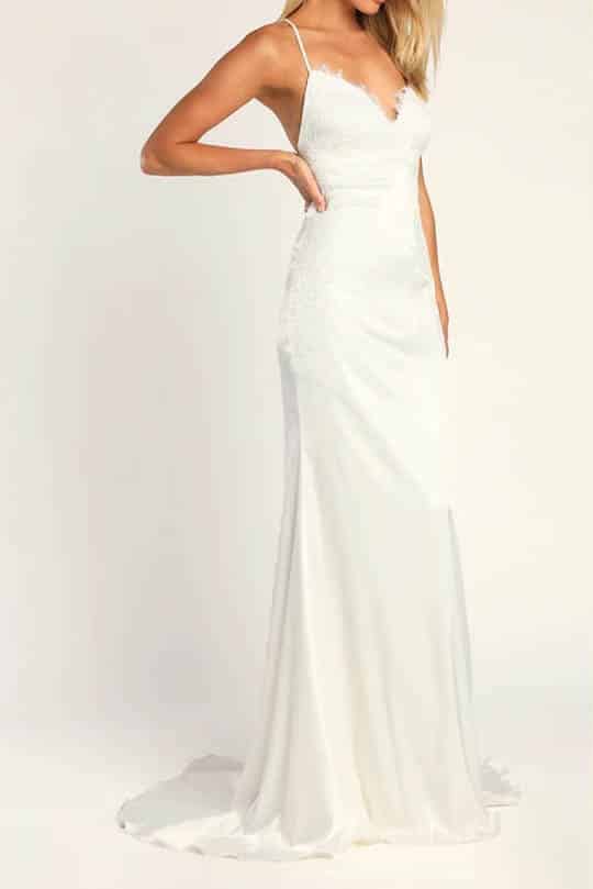 Woman wears wedding dress under $150 from Lulus with spaghetti straps and lace.