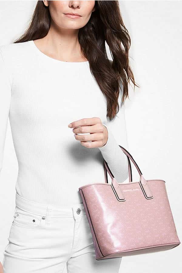 Shop these 14 best fashion and beauty labor day sales & save up to 75% 5 Model holds Michael Kors purse, discounted for a Labor Day sale.