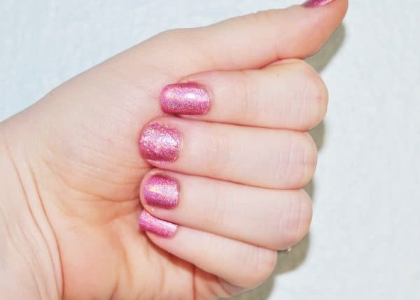 Woman's hand with painted nails after completing nail repair tutorial.