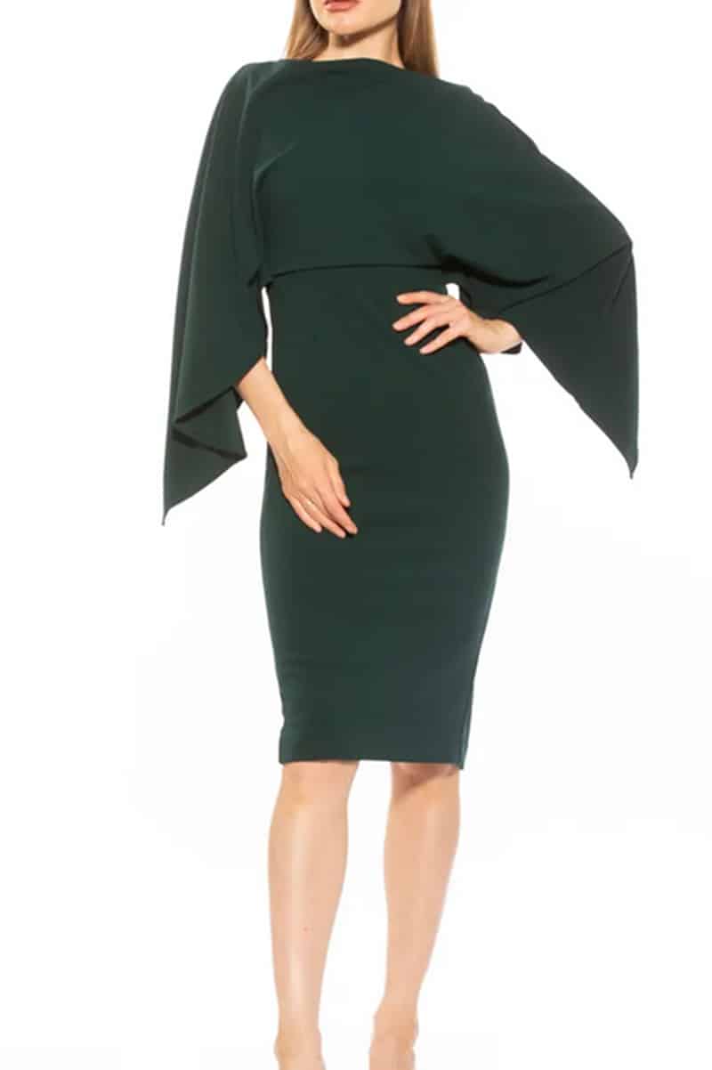 Model wears one-piece cape dress. 