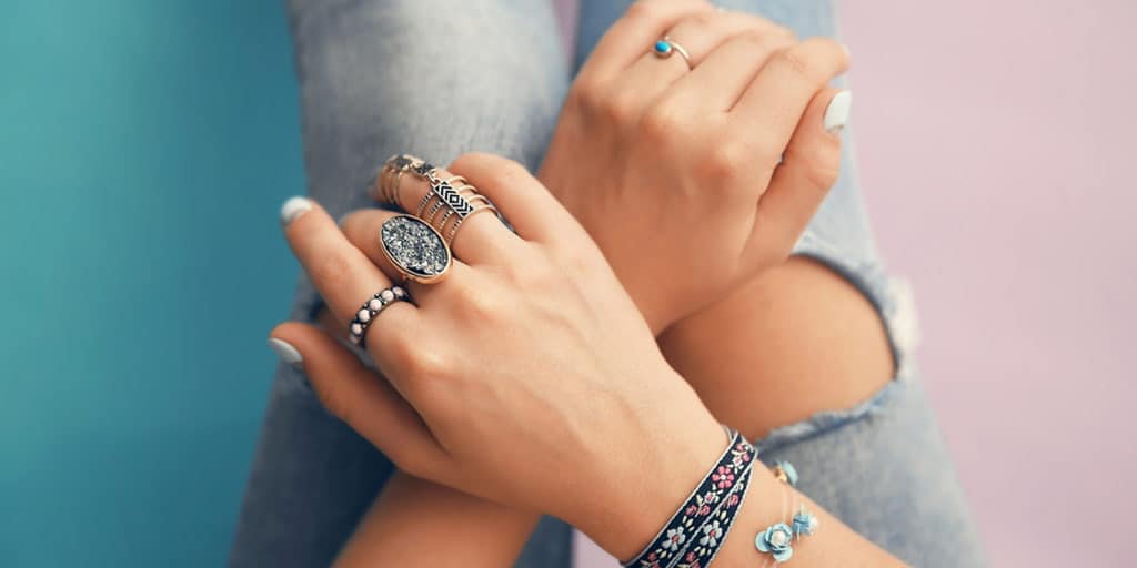 Girl wearing trendy jewelry: rings and bracelets