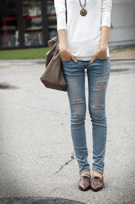 Girl wearing ripped denim and oxford shoes