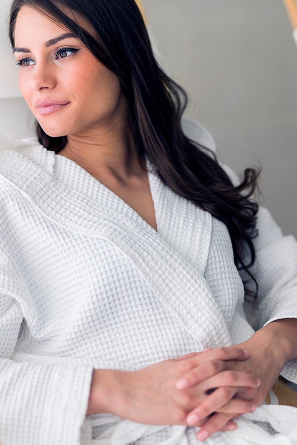 Woman relaxing in a soft, comfortable robe.