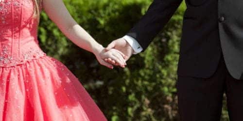 Prom dates holding hands
