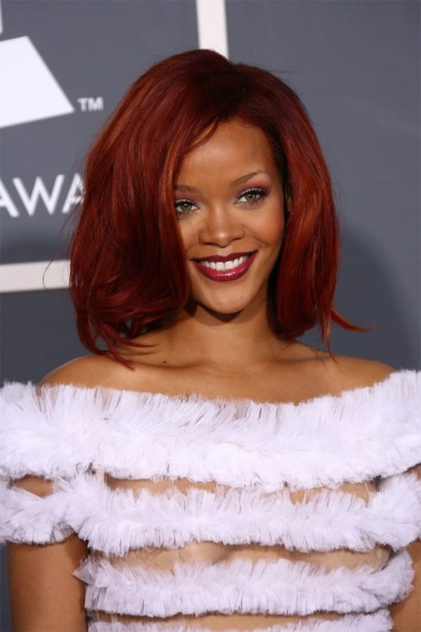 Rihanna with red lipstick and white dress