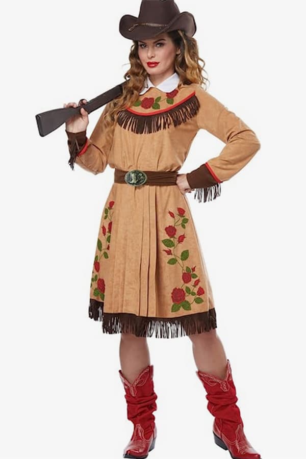 Woman wearing conservative Halloween costume of sharpshooter Annie Oakley.