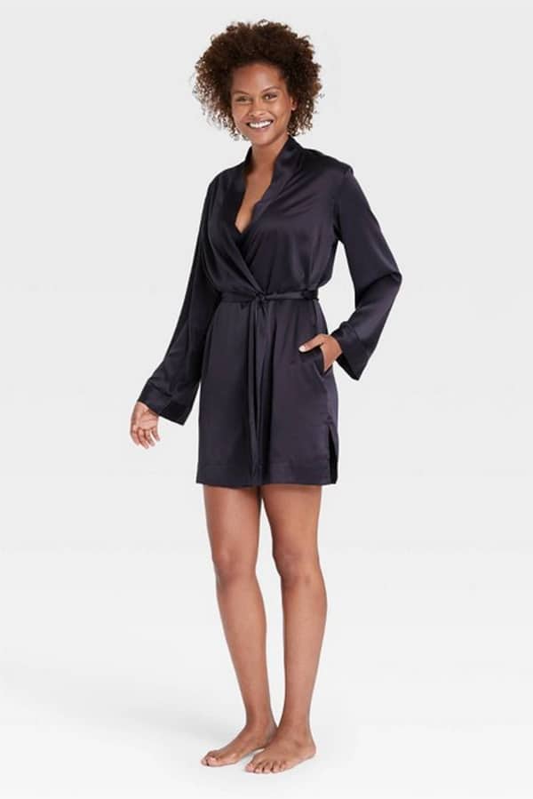 Woman wears black satin robe from Target.