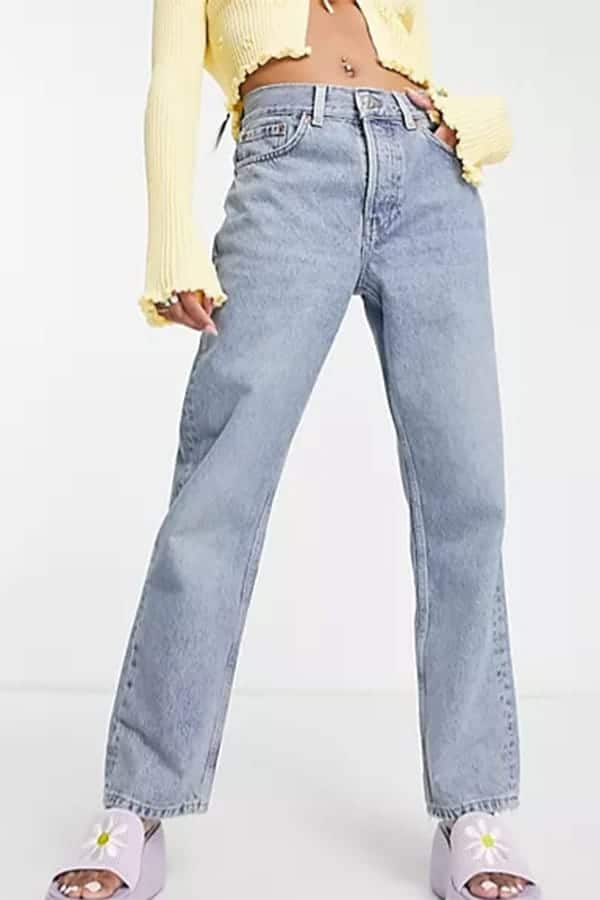 Waist-down view of model wearing Topshop petite jeans.