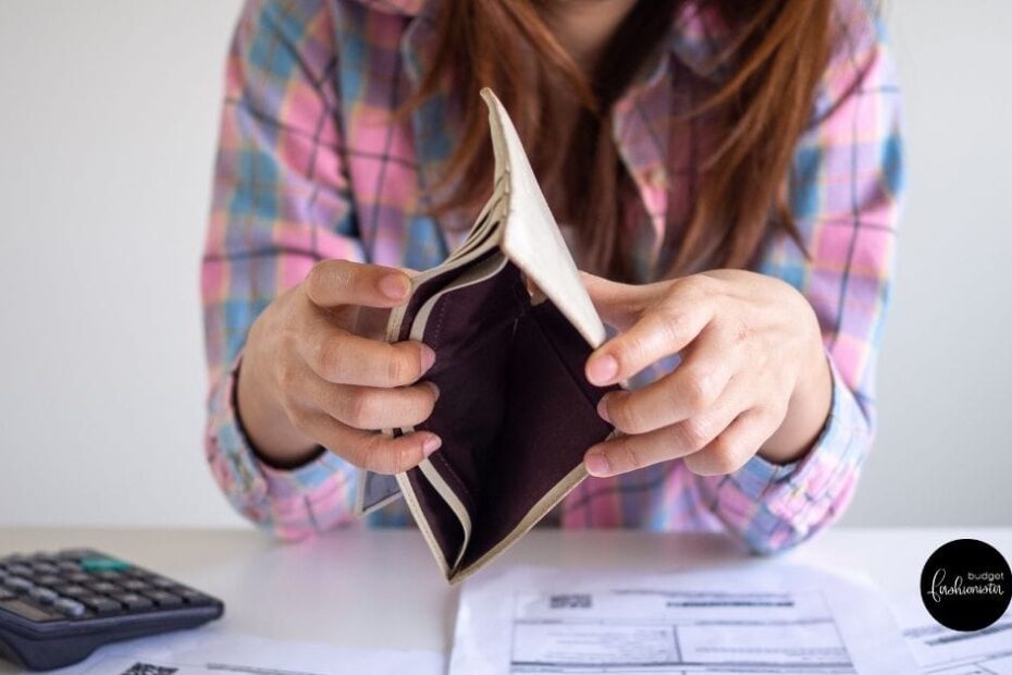 Female opens wallet to show it is empty