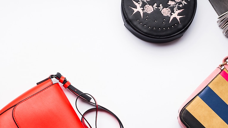 Three purses on white background to represent Dana Buchman Kohl's line.