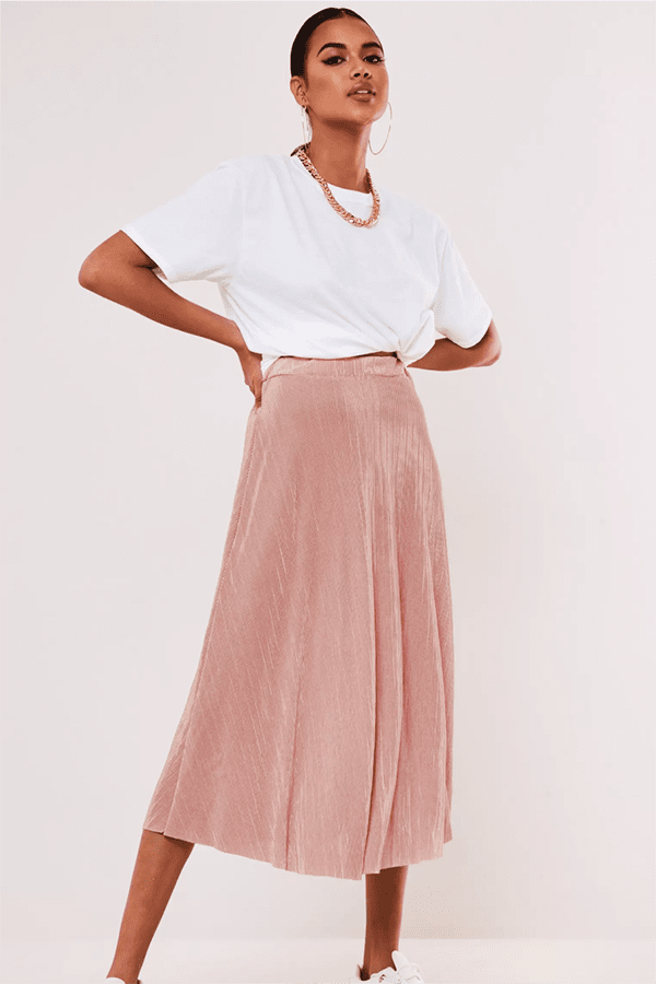 Woman wearing pink A-line midi skirt.