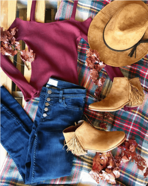 Outfit flatlay with booties and jeans