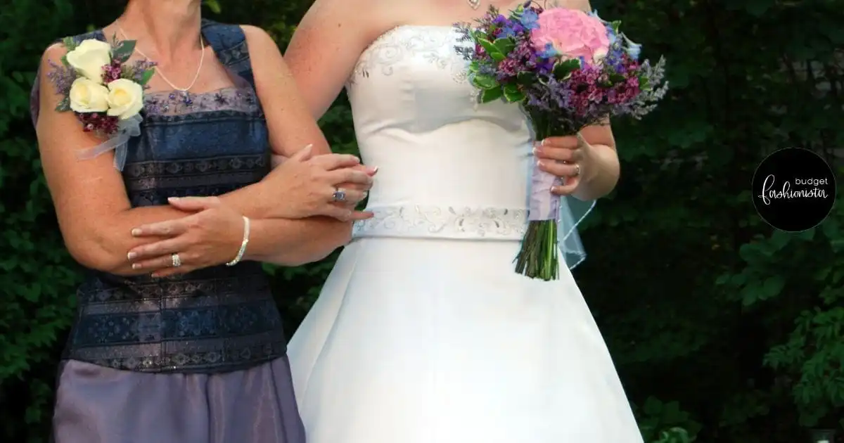 Shoulder to hip view of two women in formal dresses walking side by side.