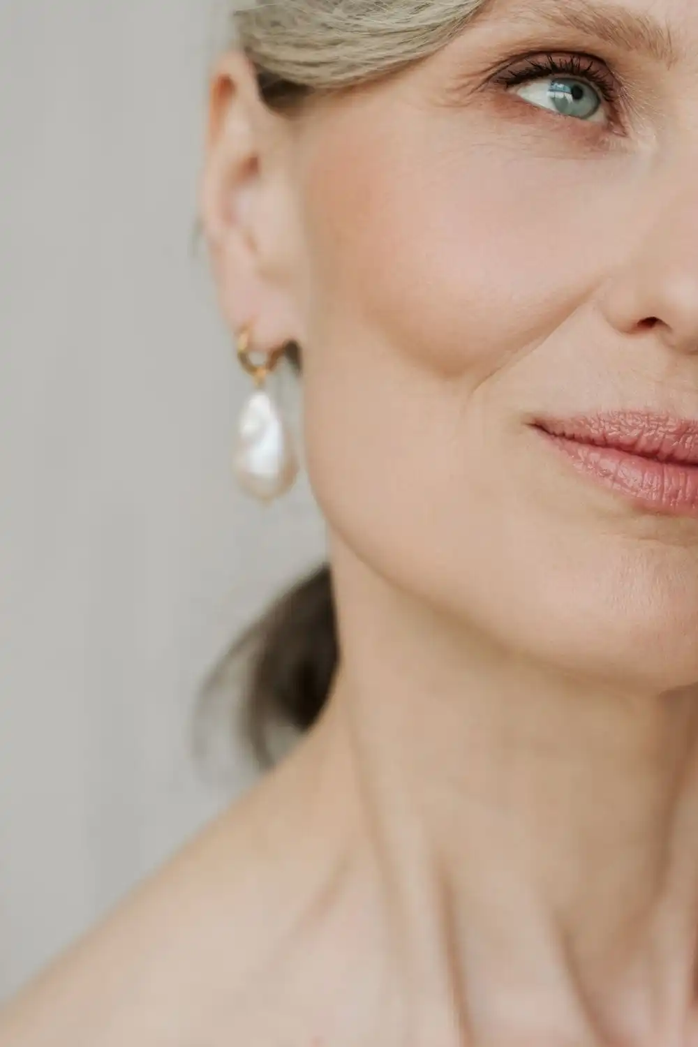 Signature accessory ideas for the 40+ fashionista 2 Close-up of older woman wearing pearl earrings.